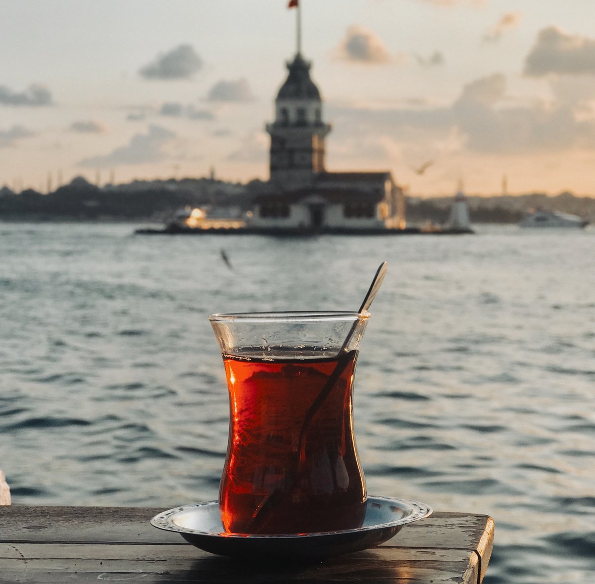 A Pitcher of Iced Black Tea on a Wooden Surface